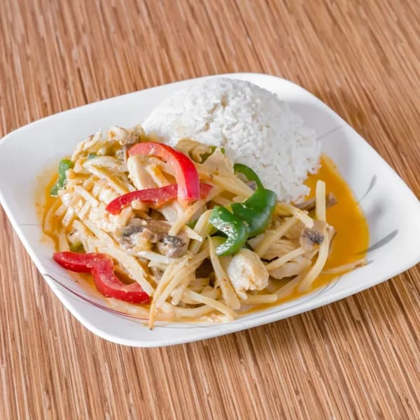Thai red curry with bamboo shoots, bell peppers, and chicken, served with white rice.