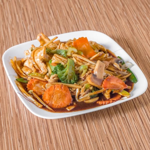 Thai stir-fry with chicken, broccoli, carrots, mushrooms, and bamboo shoots in a rich brown sauce.